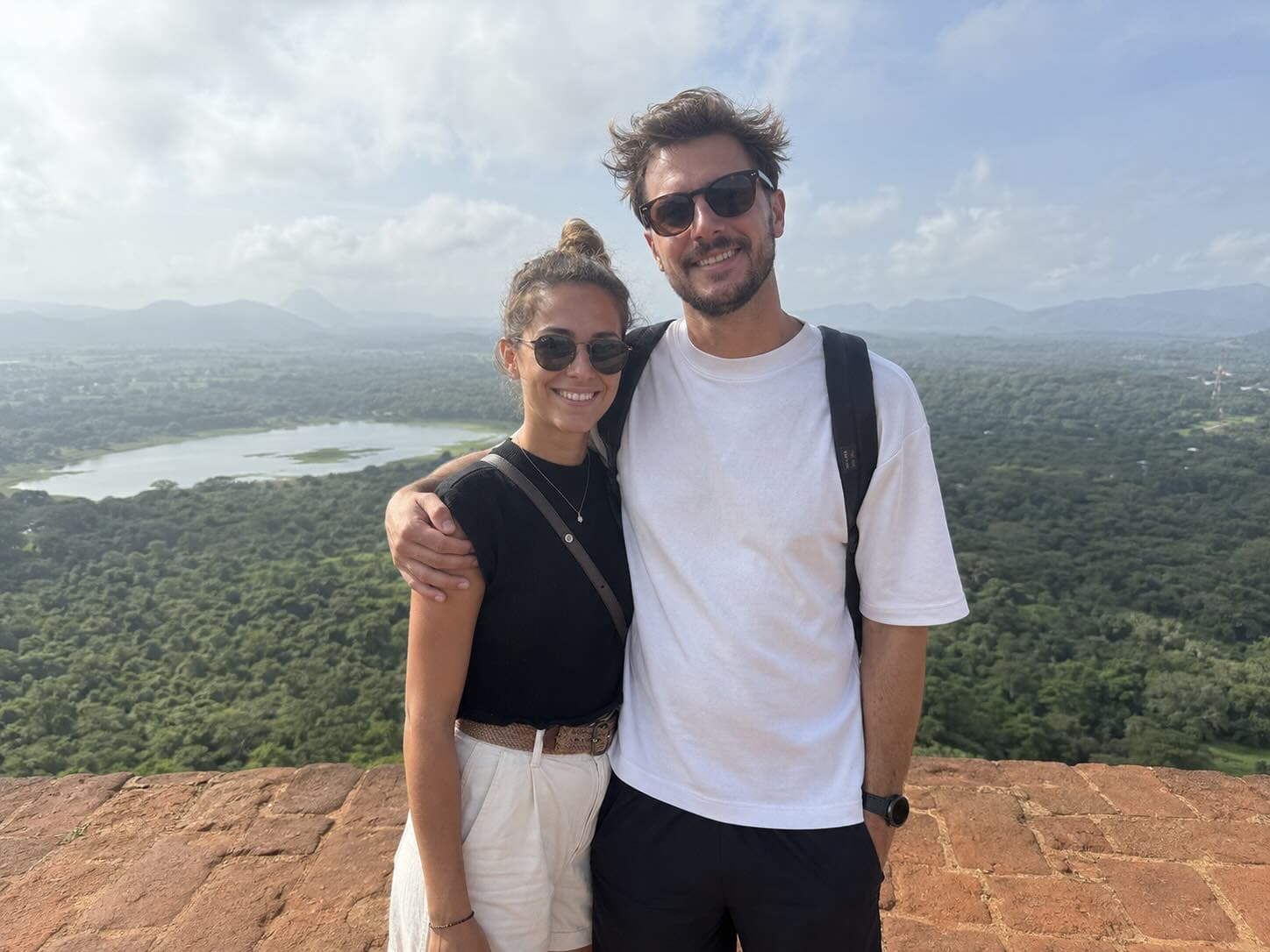 Couple planning a shared travel itinerary on their phones